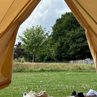 Inside of a bell tent looking at the country side